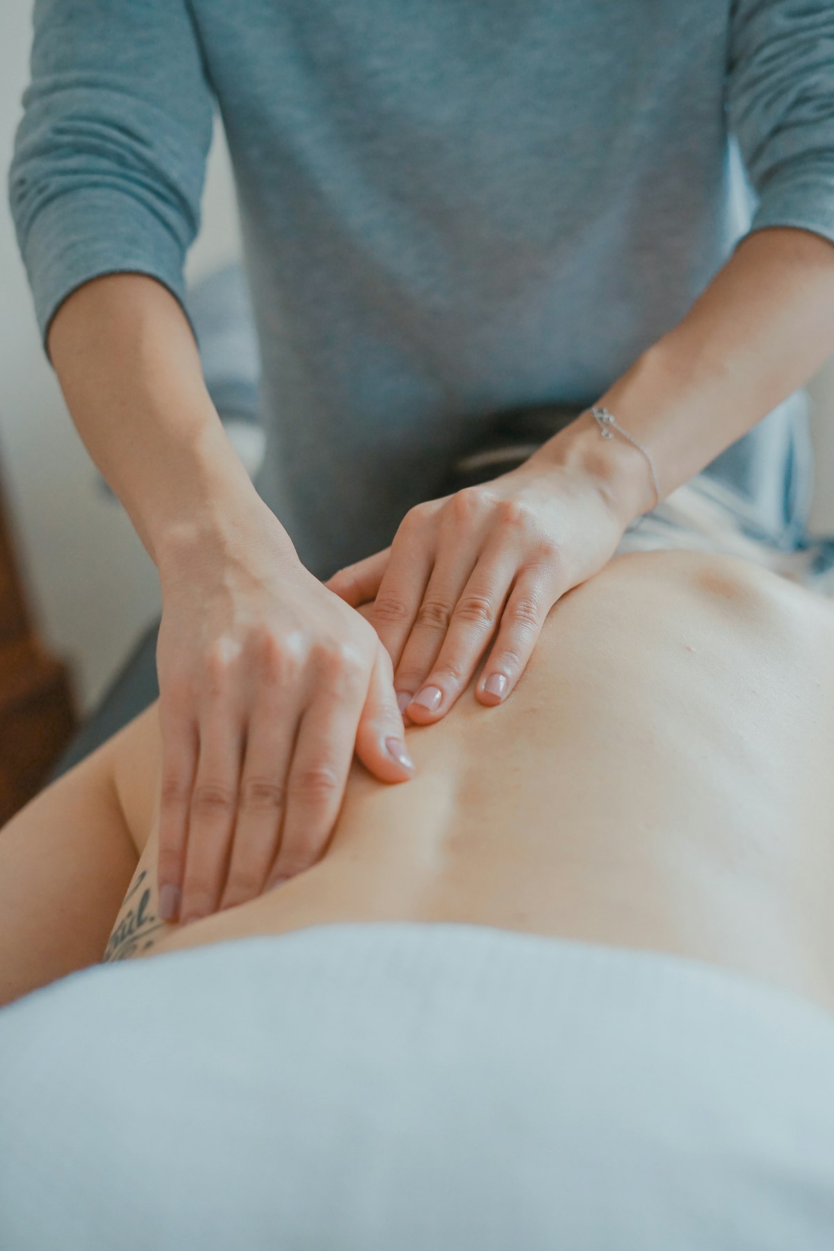 Spa massage therapist delivering a treatment in a luxury spa
